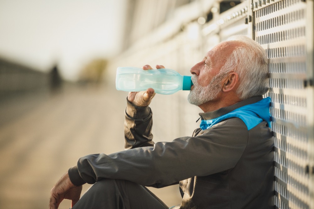 Athlete resting and drinking water after a hard session