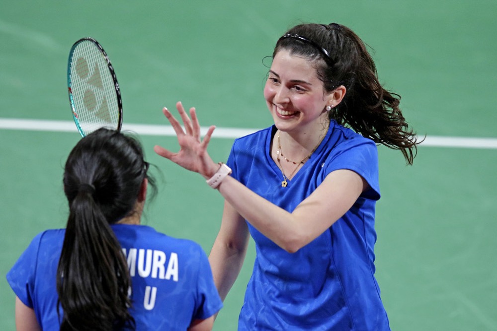 Doubles partners giving each other a high five