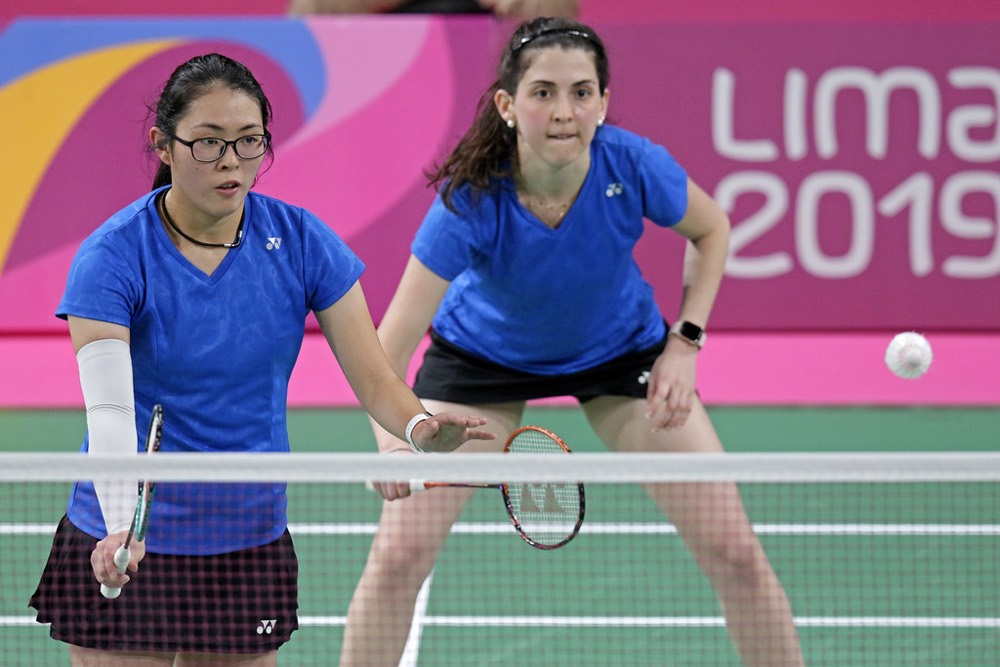 Doubles pair waiting side by side in defence