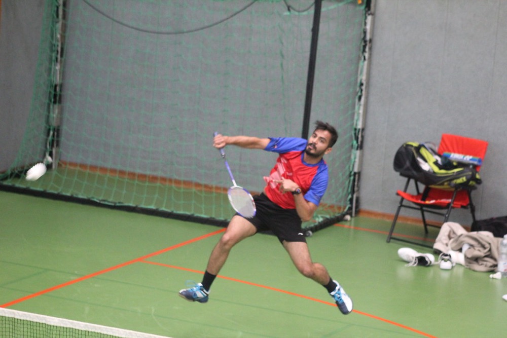Player lunging deep to reach a shuttle