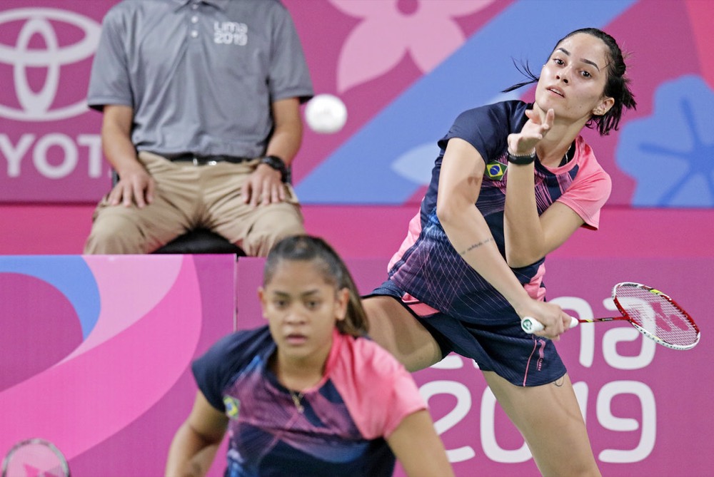 Women's doubles players in a tournament match