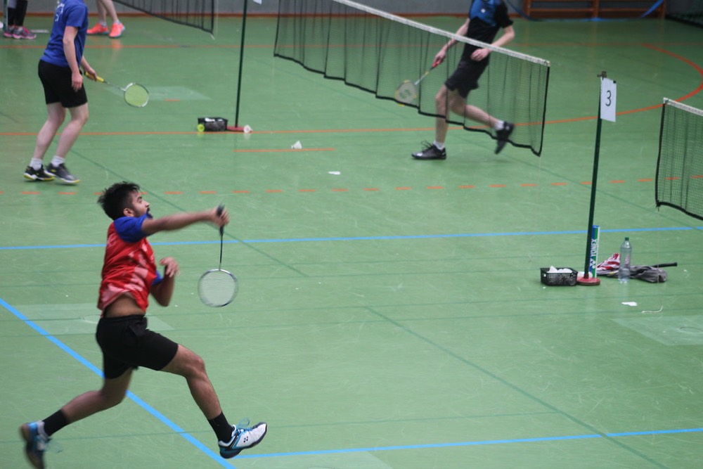 Club player hitting a forehand in a sports hall
