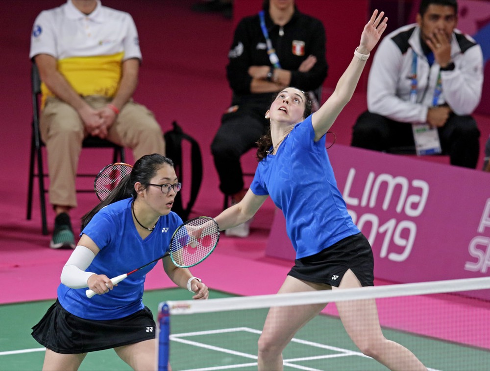 Doubles players reaching for shots on both sides