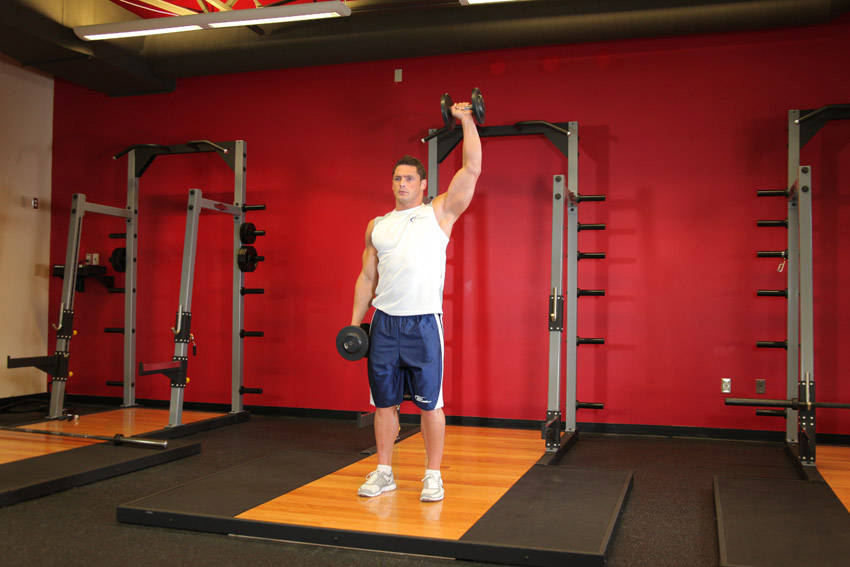 Half-kneeling dumbbell press: end position